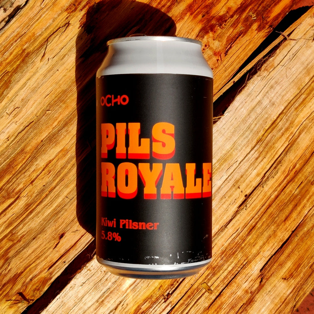 This is a photo of a can of Ocho Pills Royale that is lying down on some beautiful timber.